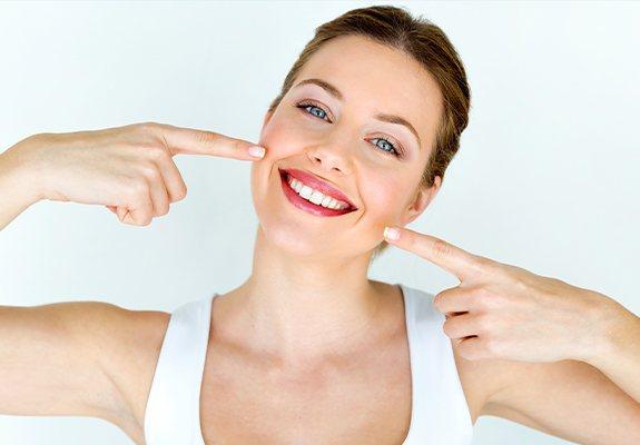 Woman pointing to healthy smile