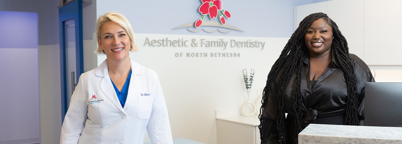 North Bethesda oral surgeon and team member smiling in reception area