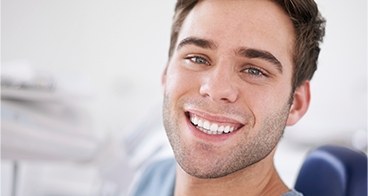 Smiling young man in dental chair