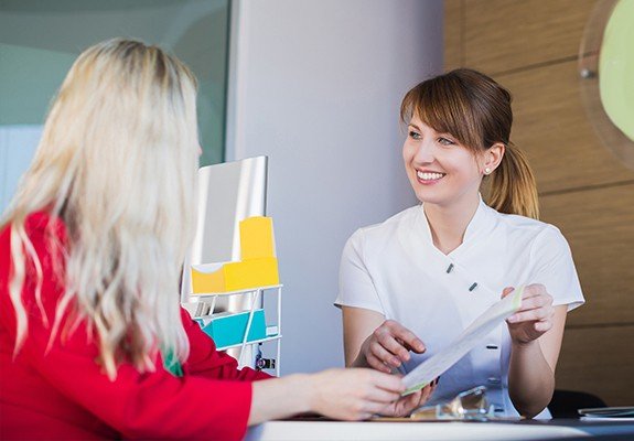 Dental team member discussing dental insurance benefits with patient