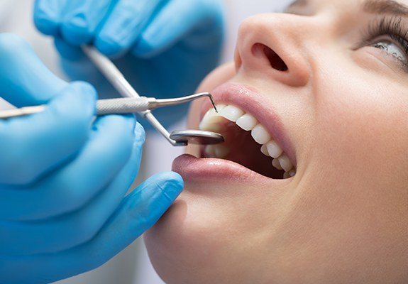 Dental patient receiving scaling and root planing treatment