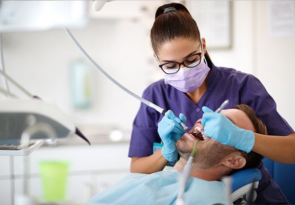 Dental patient receiving gingivectomy treatment